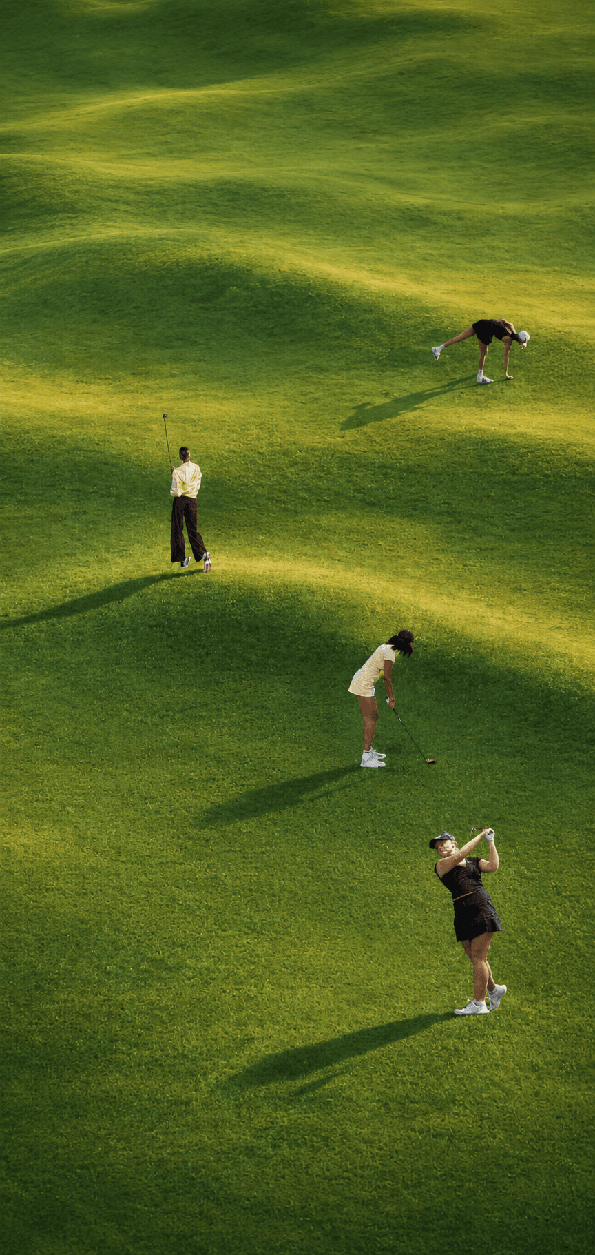 Golfers on a sunlit course